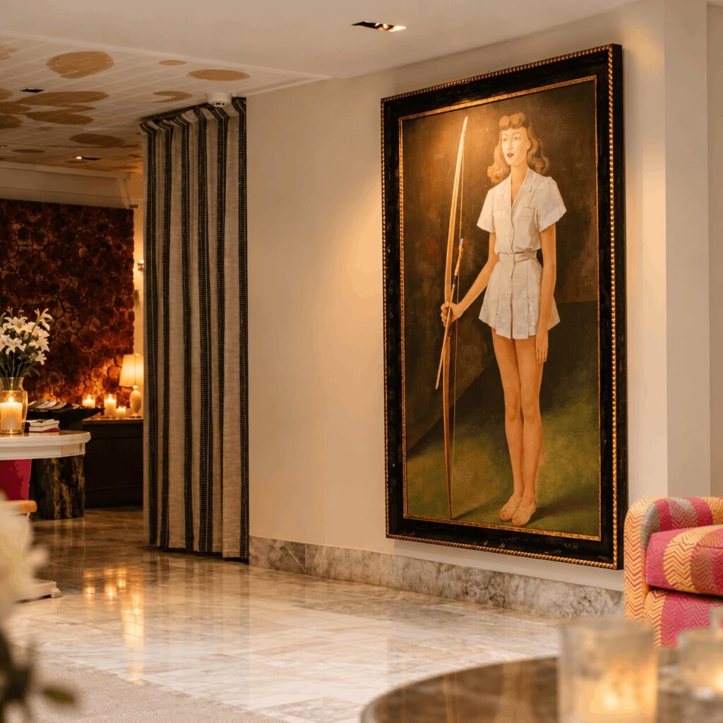 Hotel Matilda lobby with a large painting of a woman holding a bow